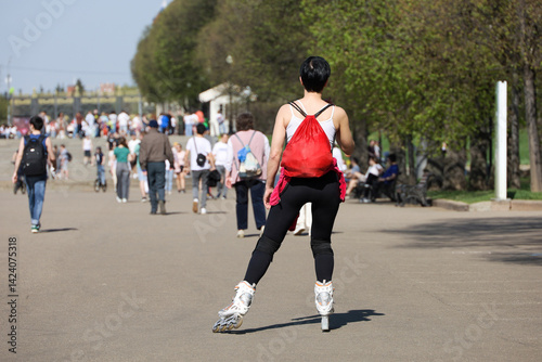 Obraz na płótnie Roller skating, girl riding on rollers on a street on people background. Concept of sport, healthy lifestyle in city w salonie