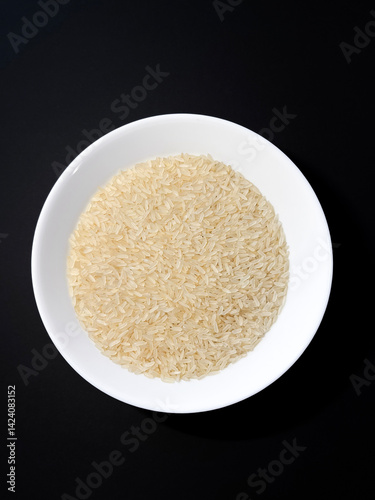 Dish of rice on dark background.