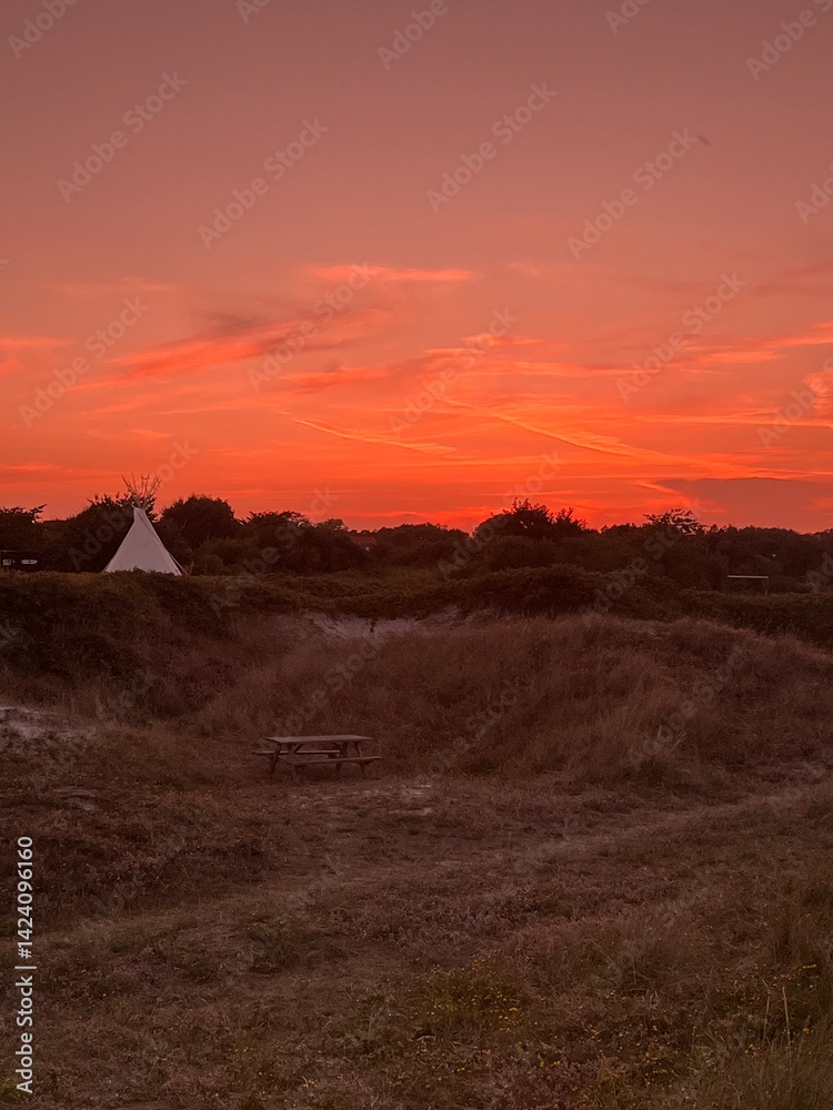 Fototapeta premium sunset over the tent and dunes