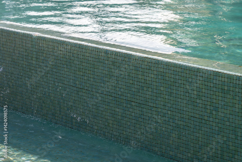 The water overflows over the edge of the pool.