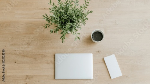 Laptop, smartphone, coffee, and plant on a light wood desk; a minimalist workspace scene.