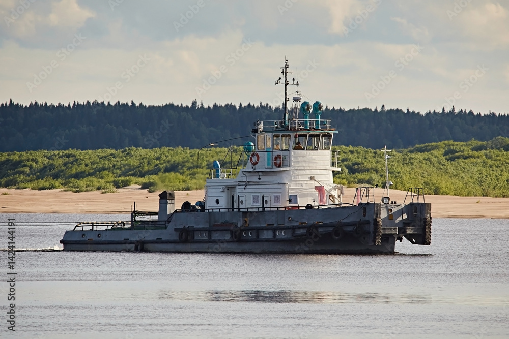 Fototapeta premium Tugboat sailing down the river, close-up