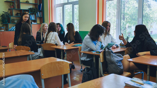 High school students collaborating in a bright classroom, engaging in discussions and sharing ideas during group work