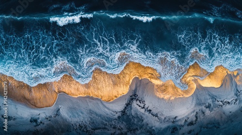 Aerial view of ocean waves crashing on sandy beach at sunset; travel, nature background (1)