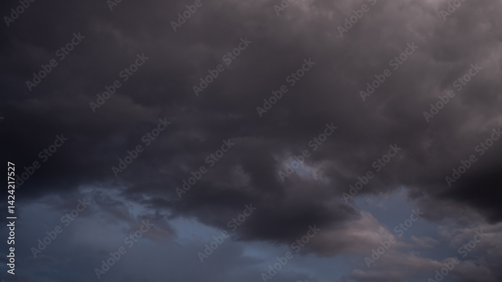 Overcast sky with dark clouds. Dark sky before a thunder-storm. The gray cloud background before rain. Overcast sky with dark clouds. Dark sky before a thunder-storm. The gray cloud background before rain.