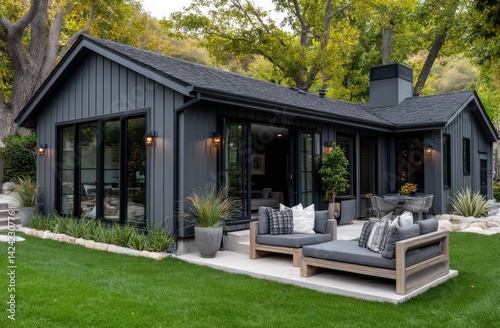 Cozy, small, single-story modern farmhouse with dark grey wood siding