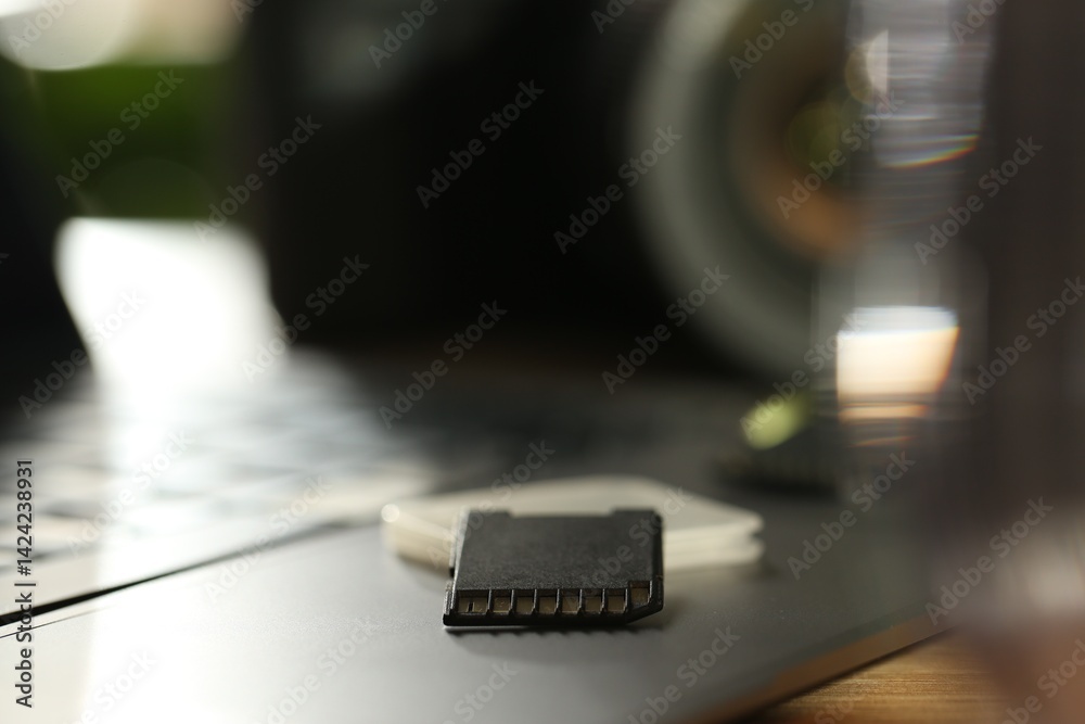 SD memory cards, holder and laptop on table, closeup SD memory cards, holder and laptop on table, closeup