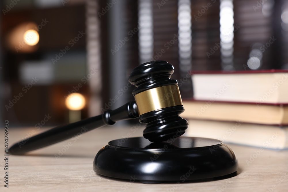 Judge's gavel and sound block on wooden table against blurred background, closeup Judge's gavel and sound block on wooden table against blurred background, closeup
