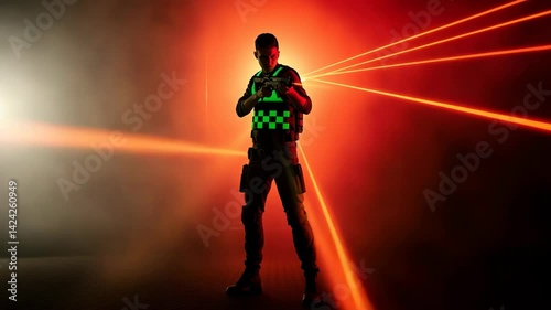 Military man shooting with a laser gun in a dark and smoky environment with red laser beams