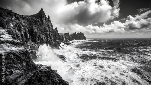 A windswept coastline with jagged cliffs, powerful waves crashing and a salty sea breeze blowing in from the ocean.