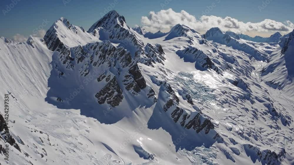 A stunning view of a snow-covered mountain range with rolling hills of snow and a bright blue sky A stunning view of a snow-covered mountain range with rolling hills of snow and a bright blue sky