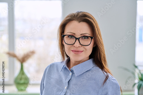 Obraz na płótnie Headshot portrait of smiling businesswoman with glasses in blue shirt w salonie