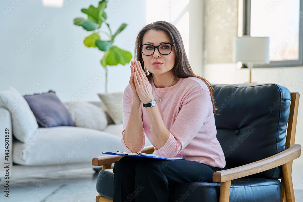 Portrait of professional psychologist therapist woman with clipboard in office