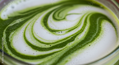 Delicious Green Matcha Latte Swirls in Frothy Milk Abstract Close Up