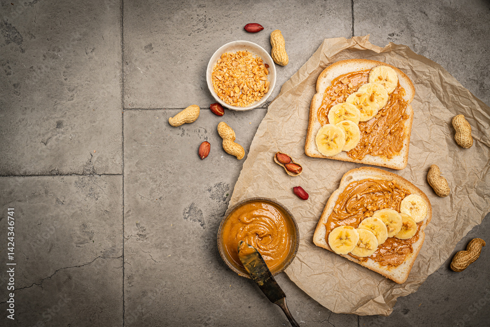 Peanut butter sandwiches on paper. Sliced bread with nuts spread. Top view of healthy protein breakfast or snack. Vegetarian lunch. Copy space.