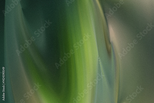 A close up shot of a vibrant green plant stalk with blurred background creating a soft abstract effect
