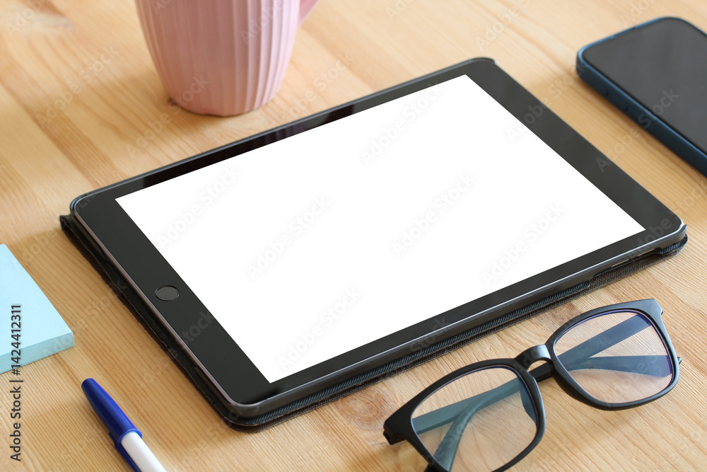 Tablet with blank screen showing empty mockup template displaying copy space on wooden table Tablet with blank screen showing empty mockup template displaying copy space on wooden table