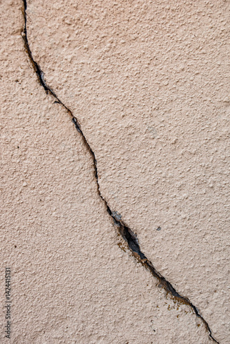textured wall with a vertical crack running from right to left