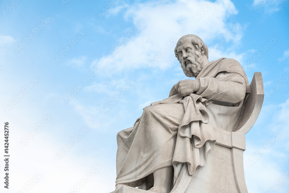 Fototapeta premium Statue of Plato from the Academy of Athens, Greece against blue sky. Popular Greek landmark and travel destination