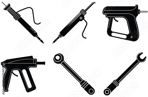 Isolated black vector silhouettes depict a set of different metal work tools and a handgun, equipment often associated with security or war