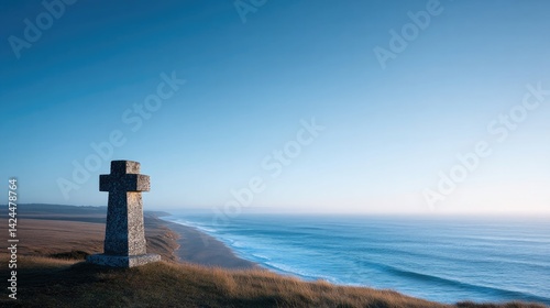 solitary weathered stone cross overlooks omaha beach silent witness of wartime history set against vast expanse of
