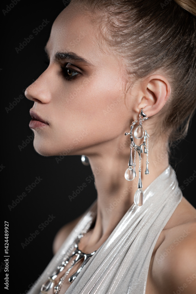 Beauty portrait of beautiful model in silver top and silver jewelry