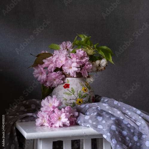 Obraz na płótnie This is a beautiful spring floral arrangement featuring a bouquet of cherry blossoms and an element of delicate drapery. w salonie