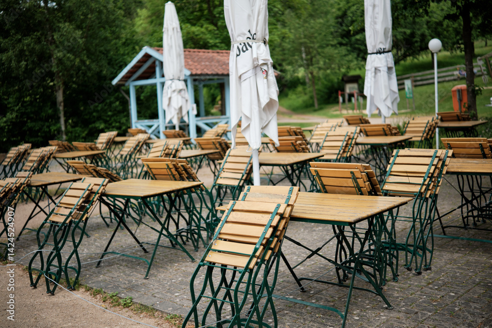 Outdoor Caf Setting with Tables and Umbrellas