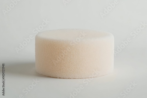 Round, light beige, textured sponge photo
