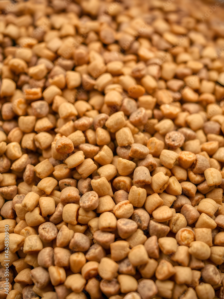 Close up shot of pet food kibble being processed, showcasing texture and detail. image captures dynamic flow of kibble, emphasizing quality Close up shot of pet food kibble being processed, showcasing texture and detail. image captures dynamic flow of kibble, emphasizing quality