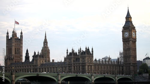 Beautiful wide shot of Elizabeth Tower and Palace of Westminster near bridge in London, England