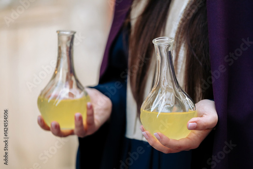 Fotografie Woman holding two glass bottles containing nard oil, used to anoint Jesus' body
