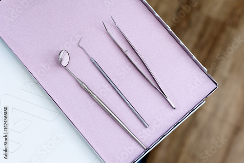 Close-up of sterilised dentist's instruments for working on teeth arranged on medical cabinet. Dental health concept