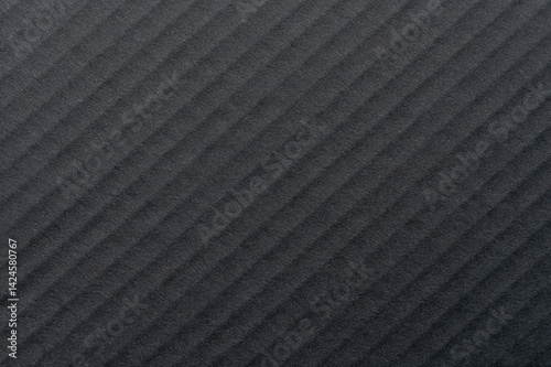 Obraz na płótnie Textured black surface showcasing diagonal lines and shadows in natural light w salonie