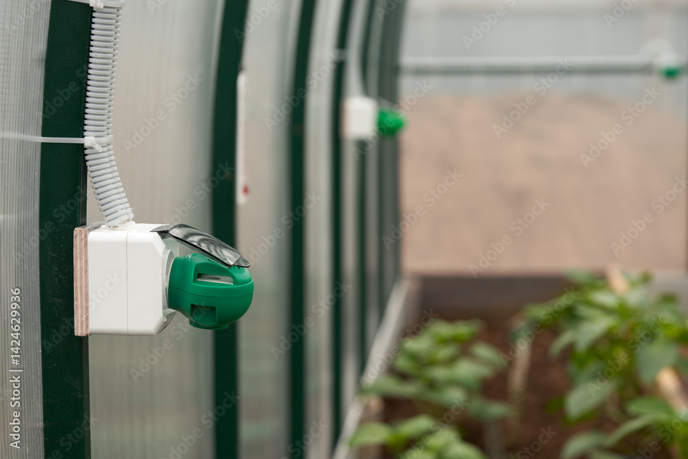 Fragment of polycarbonate greenhouse with electric fumigators inside as a way to control insect pests destroying agro crops.