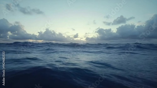 Wallpaper Mural Vast ocean horizon at sunrise or sunset.  Gentle waves gently rise and fall, under a  sky filled with clouds Torontodigital.ca