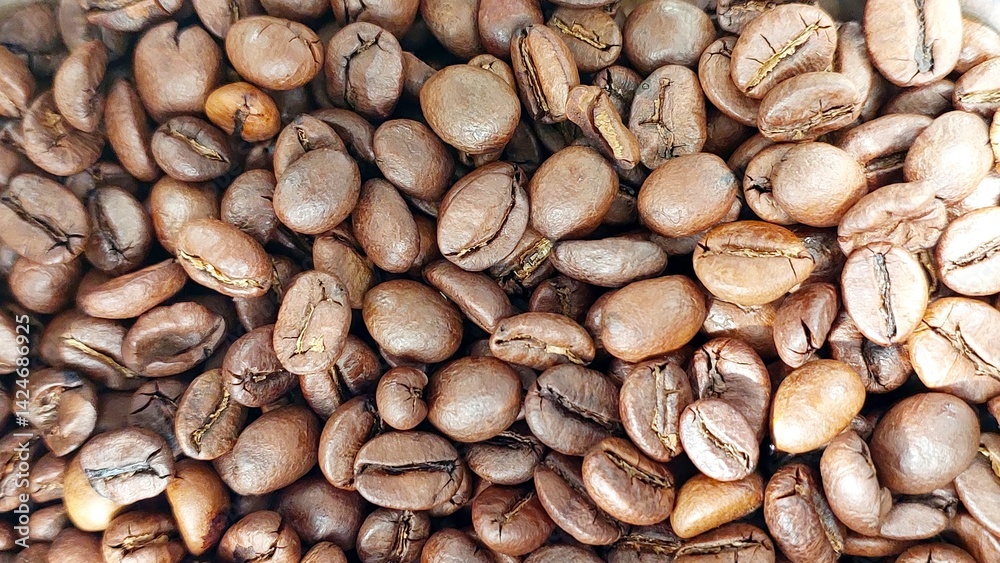 Coffee beans in a close view showcasing their rich texture and various shades of brown Coffee beans in a close view showcasing their rich texture and various shades of brown