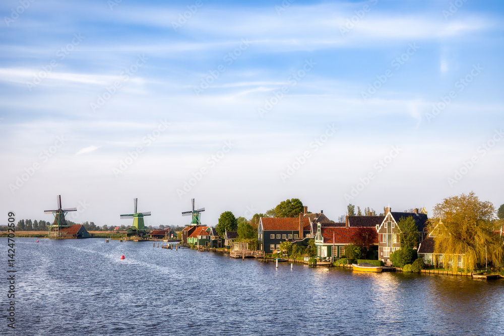 Naklejka premium Beautifull Zaanse Schans on the River Zaan Riverside in the Netherlands, with the Famous Windmills