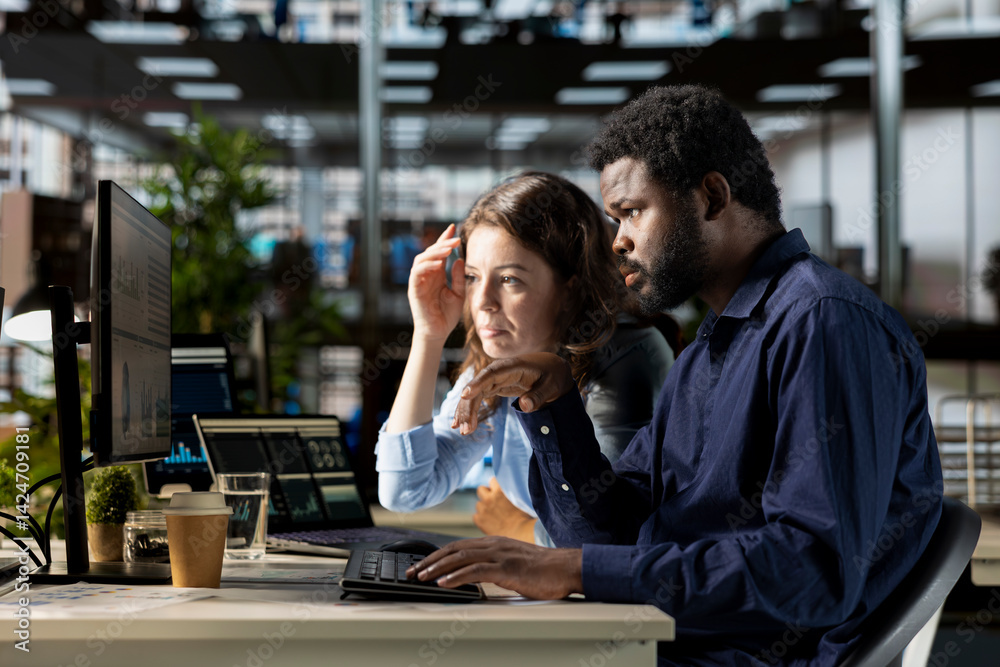 Professional team reviewing performance metrics online using pc software, corporate office life. People engaged in strategic planning to develop the multinational company financial situation.
