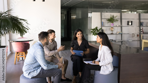 Employees gather in modern office space, engaged in interactive and collaborative discussion, smile, actively contributing to conversation during briefing, educational training event for staff members