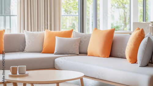 Modern living room with gray and orange pillows  