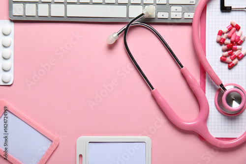 Obraz na płótnie Frame made of stethoscope, pc keyboard, badges and pills on pink background w salonie