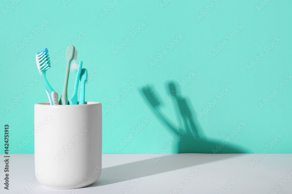 Toothbrushes in plastic holder on color background. Toothbrushes in plastic holder on color background.