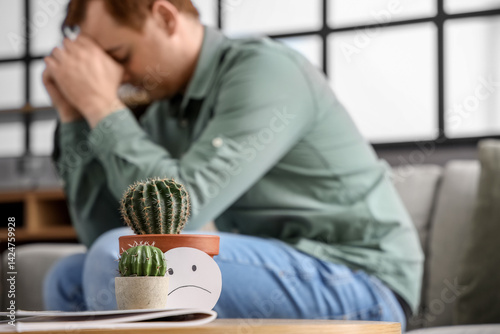 Cacti and sad smile on tabl...