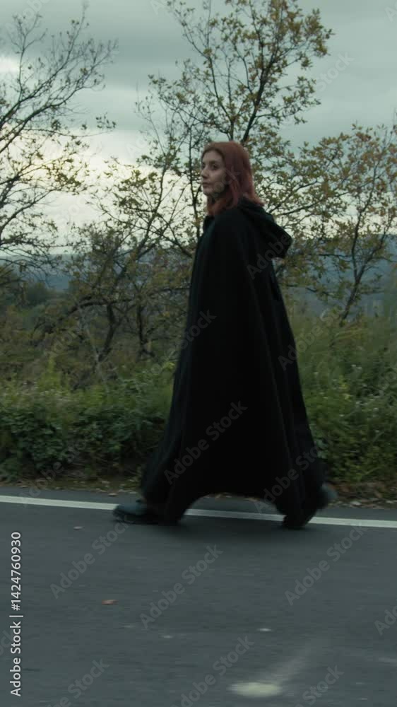 Enigmatic Secure Woman Walks With A Long Black Cloak In The Mountain Road Enigmatic Secure Woman Walks With A Long Black Cloak In The Mountain Road