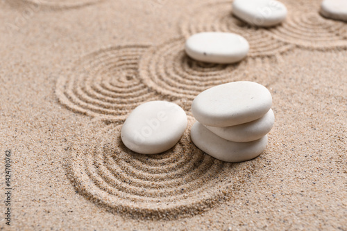 Photography White zen stones on sand with pattern