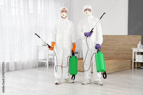 Male workers with disinfect...