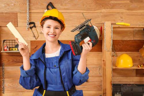 Young female carpenter with...
