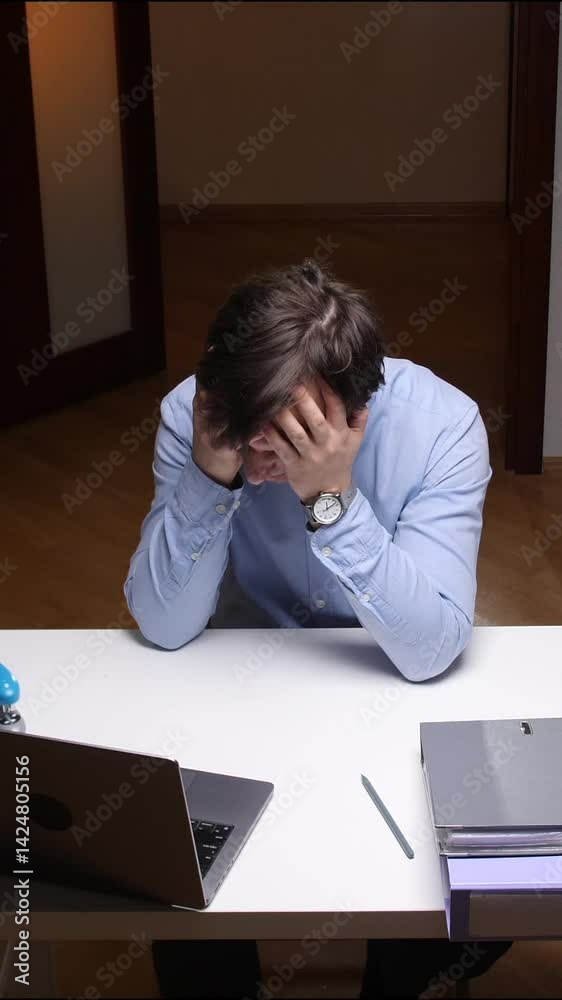vertical video Stressed office worker covering face at desk vertical video Stressed office worker covering face at desk