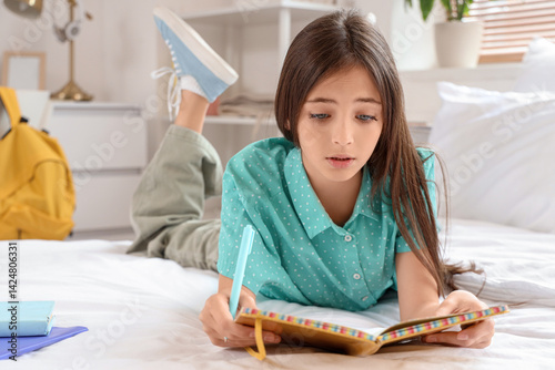 Tired little schoolgirl wit...